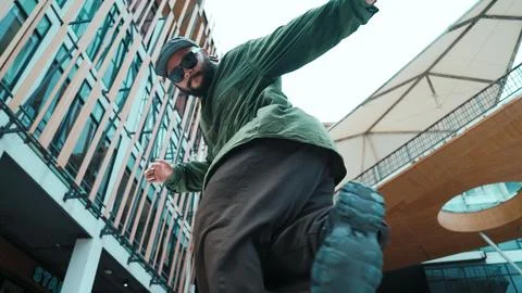 Low angle view of hipster pose in hip hop style surrounded by mall. Hiphop. 스톡 사진