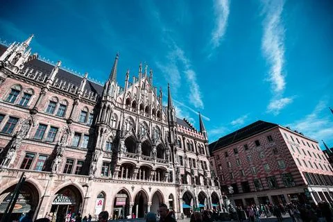 A low angle view of a historic building with ornate details and spires, situated Stock Photos
