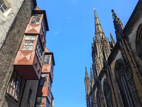 Low angle view of historic building and St Giles Cathedral against a clear blue Stock Photos