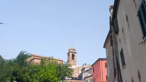 Low-angle view of the historic buildings and brick bell tower in the village Stock Footage 344254403