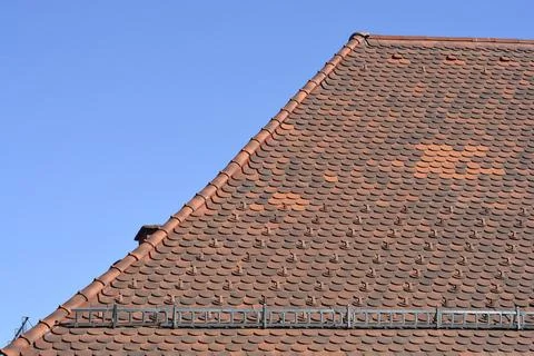 Low angle view of a historic house roof with red clay tiles Stock Photos