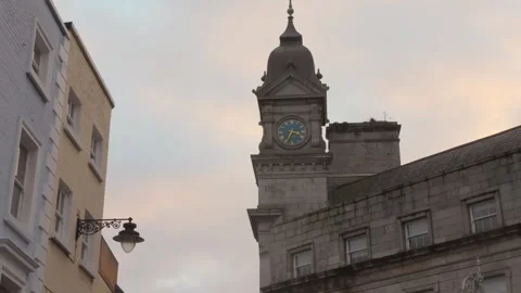 Low angle view of historic stone clock tower building against soft evening .. 스톡 동영상 337627260