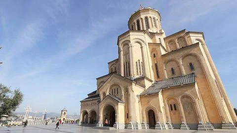 Low angle view of Holy Trinity Cathedral in Tbilisi under beautiful blue sky  Stock Photos