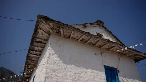 Low angle view of house roof and blue door in Nepal Vídeos de archivo 342334760