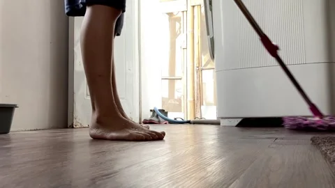 Low-Angle View Of A Housewife Mopping wooden Floor Stock Footage 343520678