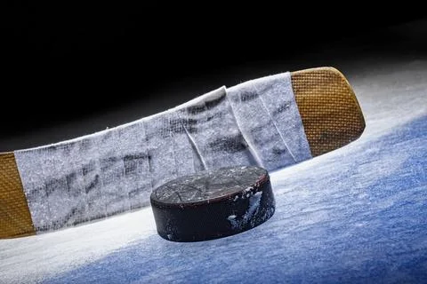Low angle view of an ice hockey stick with puck sitting on the Blue Line in the Foto stock
