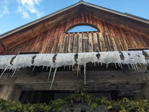 Low Angle View of Icicles on Rustic Wooden Cabin in Winter Fotos de archivo
