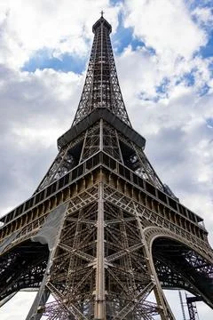 Low-angle view of the iconic Eiffel Tower in Paris, France. Stock Photos
