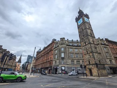 Low angle view of the iconic Tolbooth Steeple and city life at Glasgow Cross Stock Photos