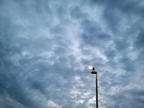 Low Angle View of Illuminated  Lighting Post Against Dark Stormy Sky Stock Photos
