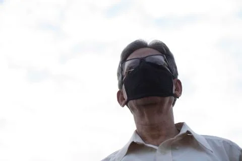 Low angle view of Indian old man with corona virus protective mask below the  Stock Photos