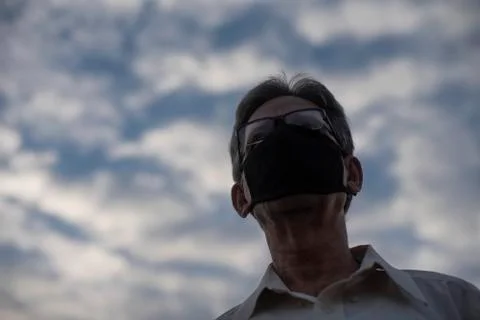 Low angle view of Indian old man with corona virus protective mask below the  Stock Photos