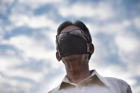 Low angle view of Indian old man with corona virus protective mask below the  Stock Photos