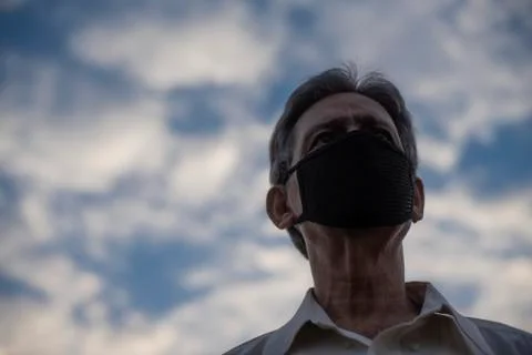Low angle view of Indian old man with corona virus protective mask below the  Stock Photos