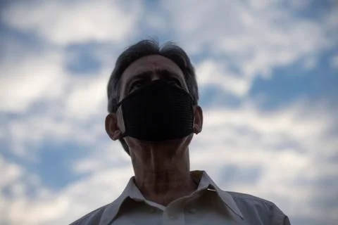 Low angle view of Indian old man with corona virus protective mask below the  Stock Photos