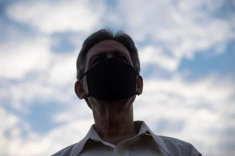 Low angle view of Indian old man with corona virus protective mask below the  Stock Photos