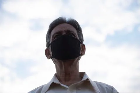 Low angle view of Indian old man with corona virus protective mask below the  Stock Photos