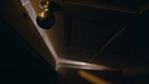 Low Angle View of Interior Door Slowly Opening in Dark Room Creating Growing Gap Stock Footage 339188912