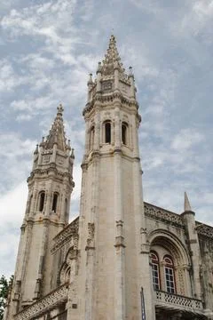 Low Angle View of Jeronimos Monastery Towers Against Cloudy Sky Stock Photos
