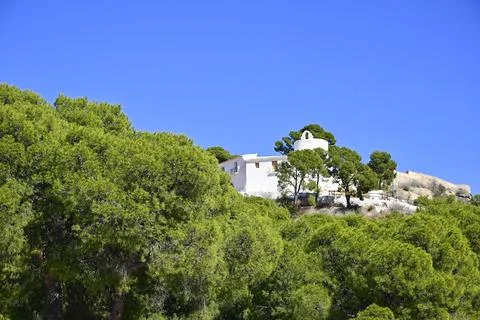 Low angle view of La Magdalena Hermitage among Mediterranean Pine trees on a Stock Photos