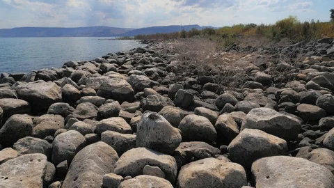 Low angle view of the lake of Kineret, Israel surrounded by rocky and Video stock 120978728