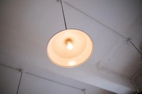 Low-angle view of a lamp hanging from white ceiling Stock-Fotos