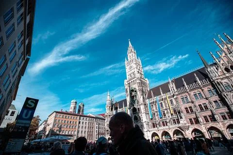 A low angle view of a large building with a tall tower,  and a busy street in Stock Photos