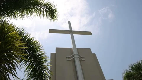 Low Angle View of Large Cross Framed By Palm Trees And Sunlight Stock-Footage 233457215