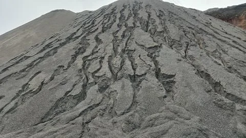 Low Angle View of Large Eroded Sand and Gravel Stockpile Hill with Erosion G Stock Photos