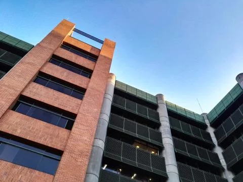 Low angle view of a large modern building with exterior brick and steel facade Fotos de archivo