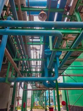 Low-angle view of large pipes arrangement in the factory Stock Photos