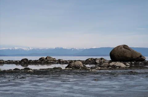 Low angle view of large rocks exposed at low tide by the sea Stock Photos