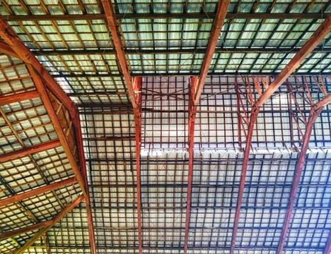 Low angle view of a large traditional wooden roof truss structure with a gr.. Stock Photos