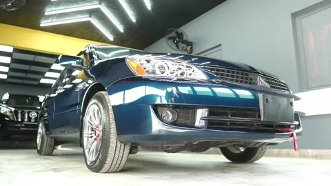 Low Angle View Of Left Side Of Mitsubishi Saloon Car In Show Room Vidéo 196869348