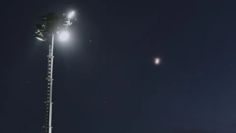 Low Angle View of Lighthouse with Floodlights in Night Sky Stock-Footage 337716781