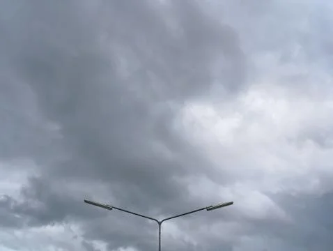 Low Angle View of Lighting Post Against Dark Cloudy Sky Background Foto stock