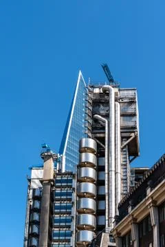 Low angle view of Lloyds Building in the City of London against blue sky Stock Photos
