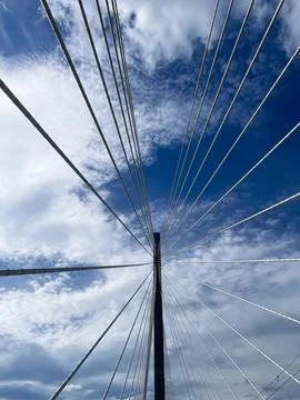 Low angle view looking up at cable stayed bridge pylon against sky Stock Photos