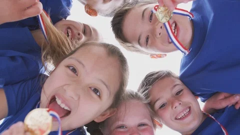 Low Angle View Looking Up Into Faces Of Children In Huddle On Sports Day Holding Vidéo 114312538