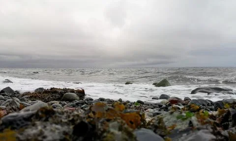 A low angle view looking out to sea on a cloudy winter day Stock Photos