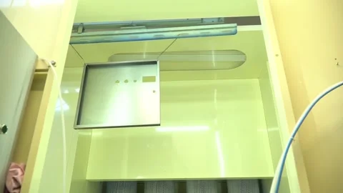 Low angle view of a machine moving a suspended metal part, factory line Stock Footage 160113605