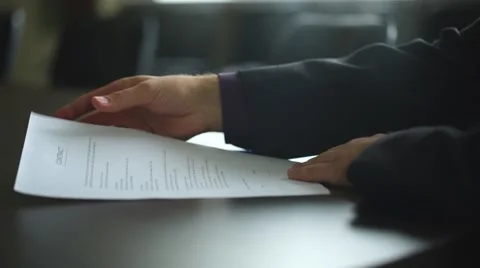 Low angle view of male hand signing contract or subscription form with a pen on Stock Footage 67878071