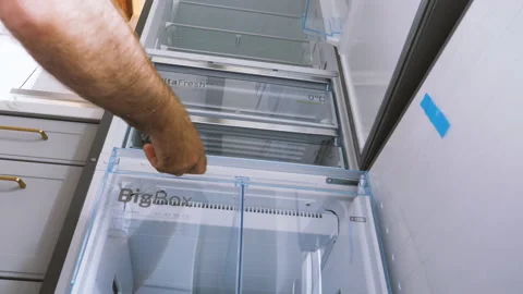Low angle view of male hand inspecting new Bosch Siemens Series 8 refrigerator Stock Footage 167291128