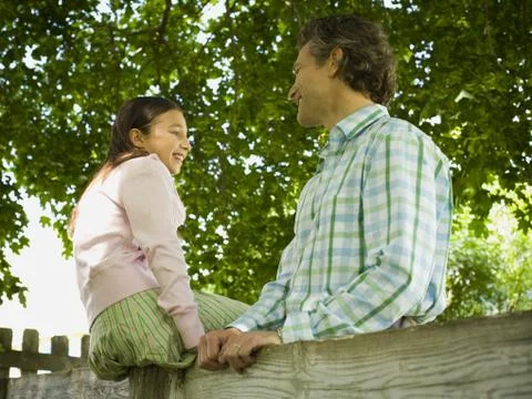 Low angle view of a man and his daughter smiling Foto stock