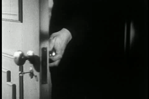 Low angle view of man entering door and locking behind him Видео 11354091
