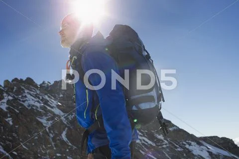 Low Angle View Of Man Hiking In Mountains, Jungfrauchjoch, Grindelwald,