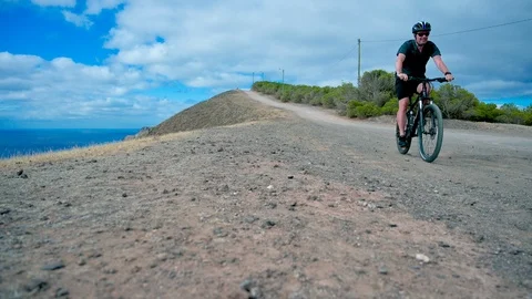 Low angle view of man on mountain bike riding downhill Stock Footage 113467002