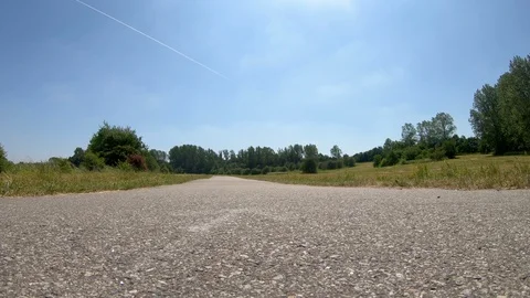 Low angle view of man riding his racing bicycle ride in the summer Stock Footage 98254893