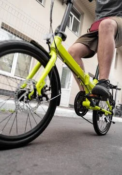 Low angle view of man riding compact folding bike for urban commuting. Stock Photos