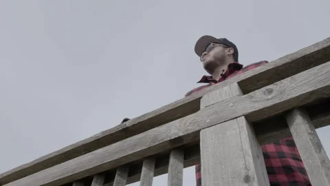 Low Angle View of Man Standing at Wooden Railing Stock Footage 343934535